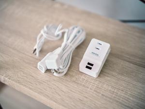 a table with a nintendo wii controller and a charger at vetta kumamoto suizenji 403 in Kumamoto