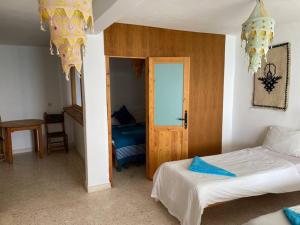 a bedroom with a bed and a room with a door at Taghazout beachfront Apartments in Taghazout +7 photos