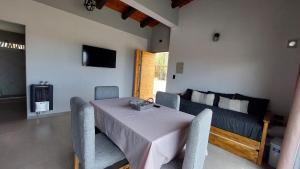 a living room with a table and a couch at Ribera de Cacheuta Lodge in Las Compuertas