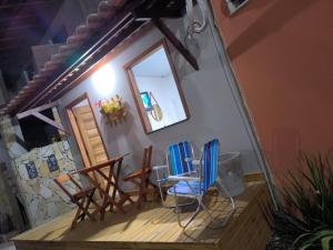 a room with chairs and a mirror on a porch at Canto do Mar Suíte in Barra Grande
