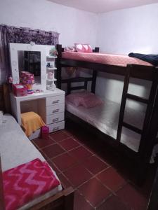 a room with two bunk beds and a desk at Apartamento Cueva del OSO II in San Cristóbal