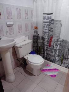 a bathroom with a white toilet and a sink at Apartamento Cueva del OSO II in San Cristóbal