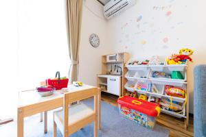 a childs room with a table and a desk at Casa Familia Aoshima in Miyazaki