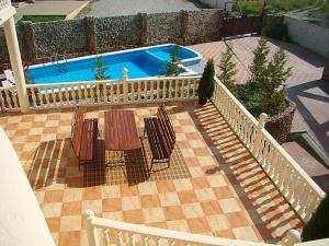 a patio with a table and chairs next to a pool at Buhta Udachi Mini-hotel in Gelendzhik