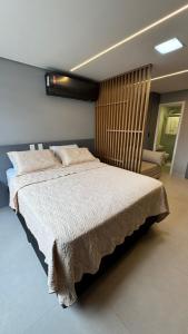 a bedroom with a large bed and a chair at Vert House in João Pessoa +25 photos