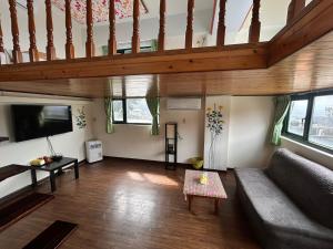 a living room with a couch and a tv at Old Street Seaview Homestay in Jiufen +103 photos