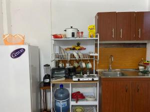 a small kitchen with a sink and a counter top at Aguiñada's House in El Rosario