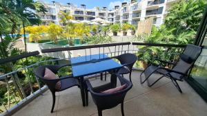 a blue table and chairs on a balcony with a building at One bed Apartment Nai Yang in Nai Yang Beach