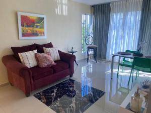 a living room with a couch and a table at Tiny Apartment By Merengue House ,8 minutos airport in Santo Domingo