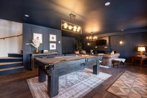 a large living room with a pool table in it at Chalet du Lac Rougeaud in Mont-Blanc