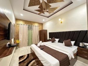 a hotel room with two beds and a television at Saanjh Riverside Resort in Mahabaleshwar