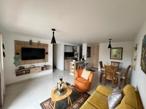 a living room with a couch and a table at Mallorca Samaria Apartment in Ibagué