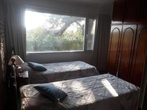 En eller flere senge i et værelse på La Paz Casa de campo