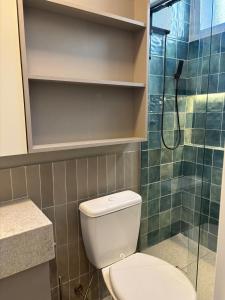 a bathroom with a toilet and a shower at Studio luxuoso in Porto Alegre +23 photos