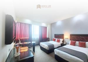Postel nebo postele na pokoji v ubytování Hock Lee Hotel & Residences