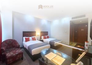 Postel nebo postele na pokoji v ubytování Hock Lee Hotel & Residences