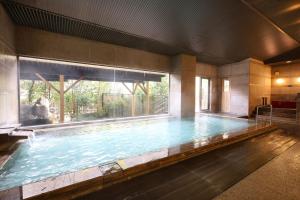 a large swimming pool with a large window at TAOYA Kawaji in Nikko