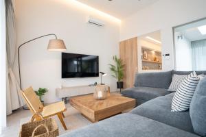 a living room with a couch and a table at Tamagusuku Terrace in Nanjo