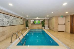 a swimming pool in a room with a tv at Darkmen Hotel 2 in Istanbul