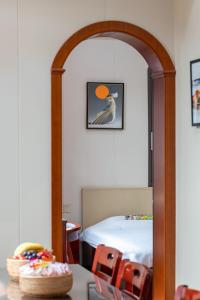 a room with a bed and a table with chairs at Kaibu Courtyard Superior Apartment, Changjiang Cable Car Nanbin Road, Chongqing in Chongqing