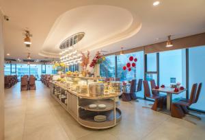 a restaurant with tables and chairs and windows at V Hotel Nha Trang in Nha Trang +168 photos