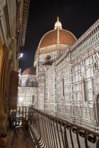 a large building with a clock on the top of it at Granduomo Charming Accomodation in Florence