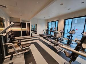a gym with a row of treadmills and ellipticals at QT Singapore in Singapore