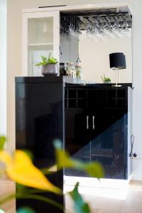 a kitchen with a black cabinet and a mirror at Rustic Point Cook Family Home near Sanctuary Lakes in Point Cook