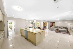 a large kitchen and living room with a couch at Rustic Point Cook Family Home near Sanctuary Lakes in Point Cook