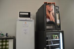 a microwave oven sitting on top of a refrigerator at Coimbra Portagem Hostel in Coimbra