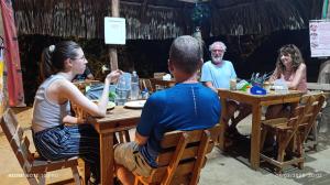 a group of people sitting at a table at Hostal El Eden Dentro del Parque Tayrona in El Zaino