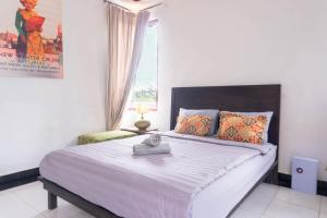a bedroom with a large bed and a window at Aurora Holiday House Kintamani in Kintamani +27 photos