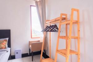 a room with a ladder and shoes on a wall at Aurora Holiday House Kintamani in Kintamani