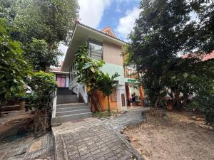 a house with stairs leading up to it at Sawasdee House in Lamai