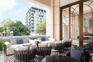 a patio with chairs and couches on a building at Radisson Hotel Chateau de Bangkok in Bangkok +87 photos