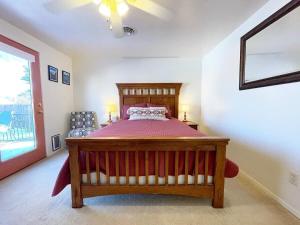 a bedroom with a wooden bed and a window at Sandstone Gazing big backyard Sleeps 10 in Kanab