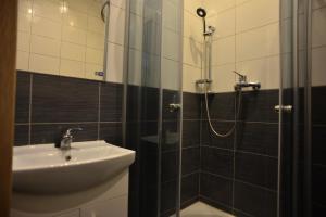 a bathroom with a sink and a shower at SHIRE Gdynia in Gdynia +17 photos