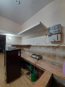 a kitchen with a wooden counter top in a room at Jalsa in Kānpur