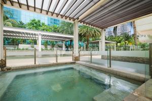 a swimming pool in the middle of a building at Chaya by Kozystay - Grogol in Jakarta