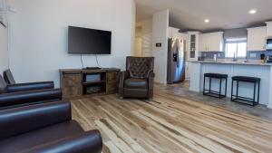 a living room with a couch and a kitchen at Cute Kanab Cottage Pet-Friendly & Modern in Kanab