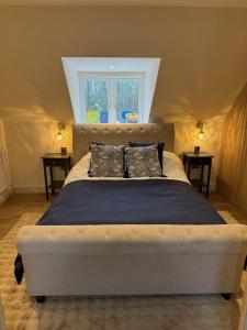 a bedroom with a large bed in a tent at Dukes Flat in Ampney Saint Peter