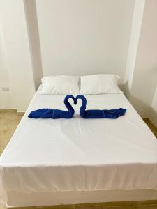 Rúm í herbergi á Hotel Dauphin Rest