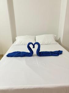 Rúm í herbergi á Hotel Dauphin Rest