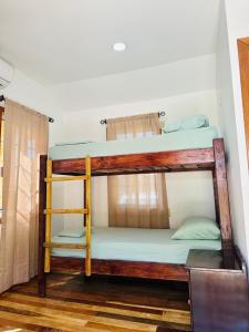 a couple of bunk beds in a room at Silver Sand, Placencia in Placencia +13 photos