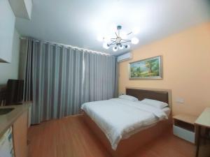 Voodi või voodid majutusasutuse Qingdao Mi Apartment toas