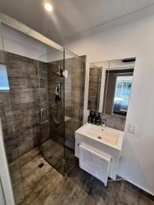 a bathroom with a sink and a shower at Family Paradise Retreat 3BRHaven in Rolleston