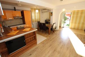 a kitchen and living room with a table and chairs at Apartment Milica in Petrovac na Moru