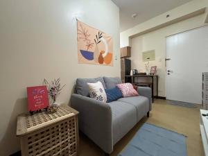 a living room with a couch and a table at Bless View at 16th in Manila