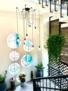a group of circles hanging on a wall with plants at Canopy Family Villa in Siem Reap