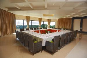 a long dining room with a long table and chairs at Germanus Springs Kodaikanal in Kodaikānāl